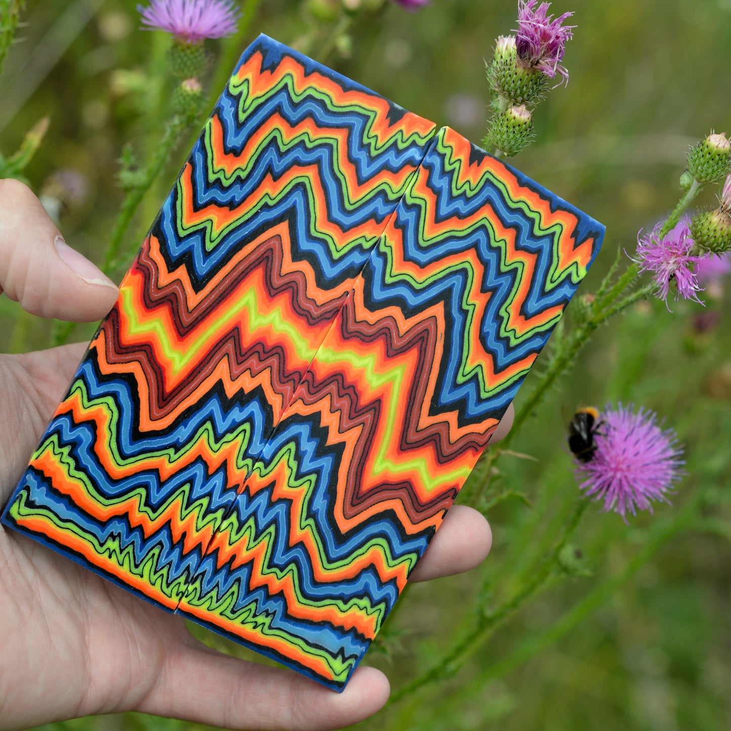 High-contrast neon micarta block with layered zigzag pattern for knife handle making