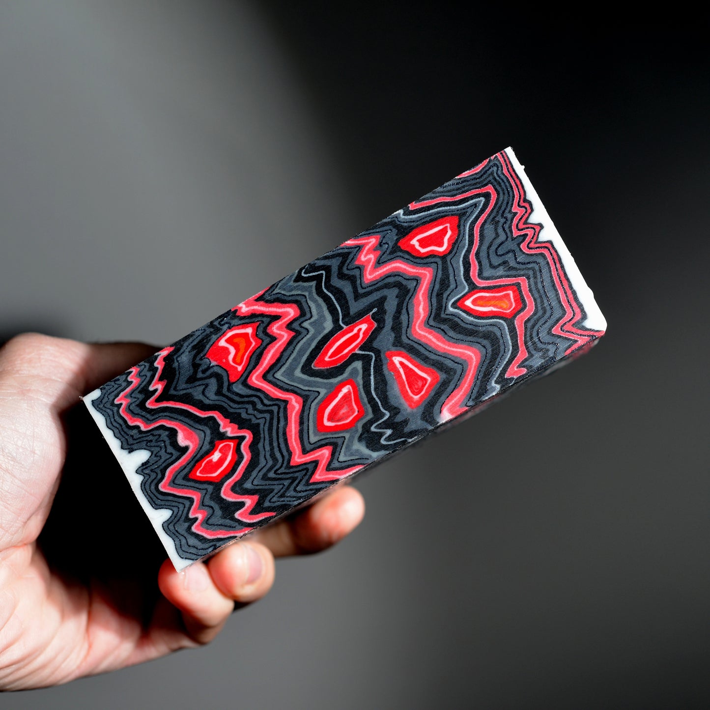 Pair of handmade micarta knife scales with red and black zigzag layered pattern