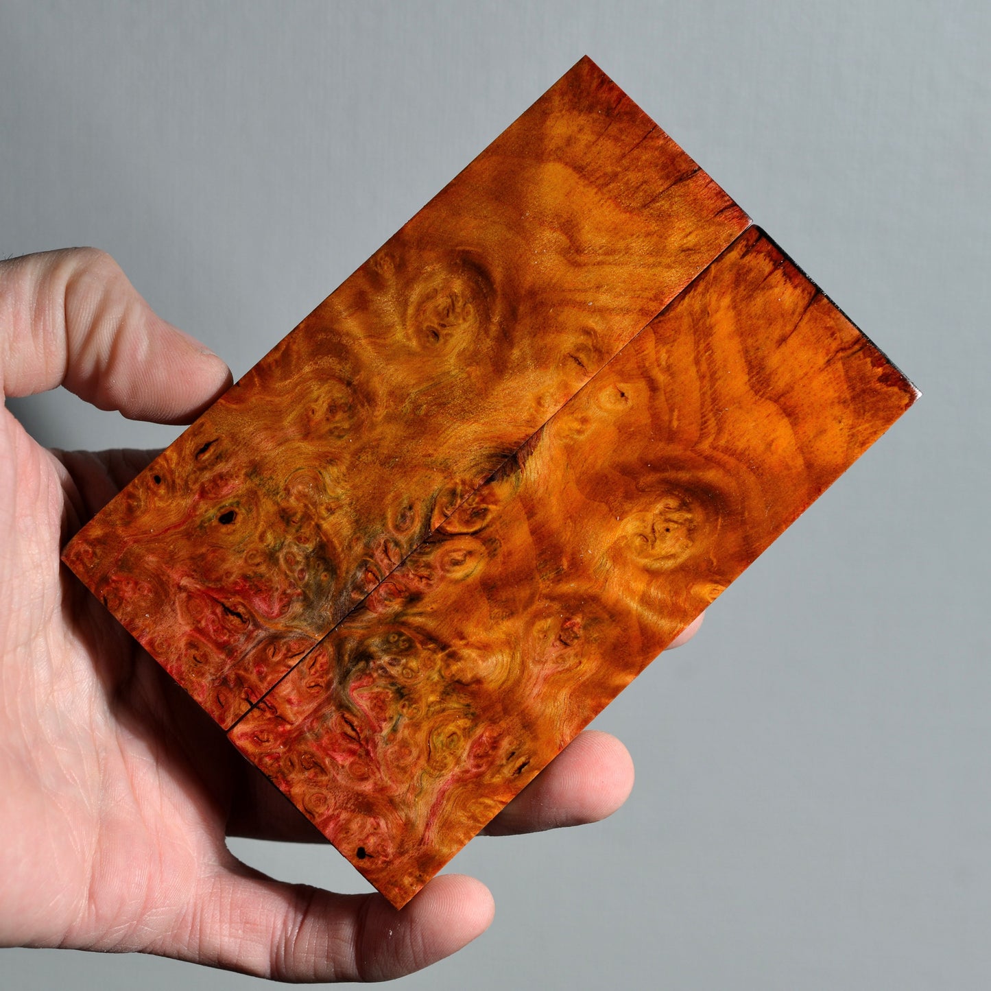 Pair of stabilized alder burl knife handle scales with warm amber and red burl figure, suitable for custom knife handle making.
