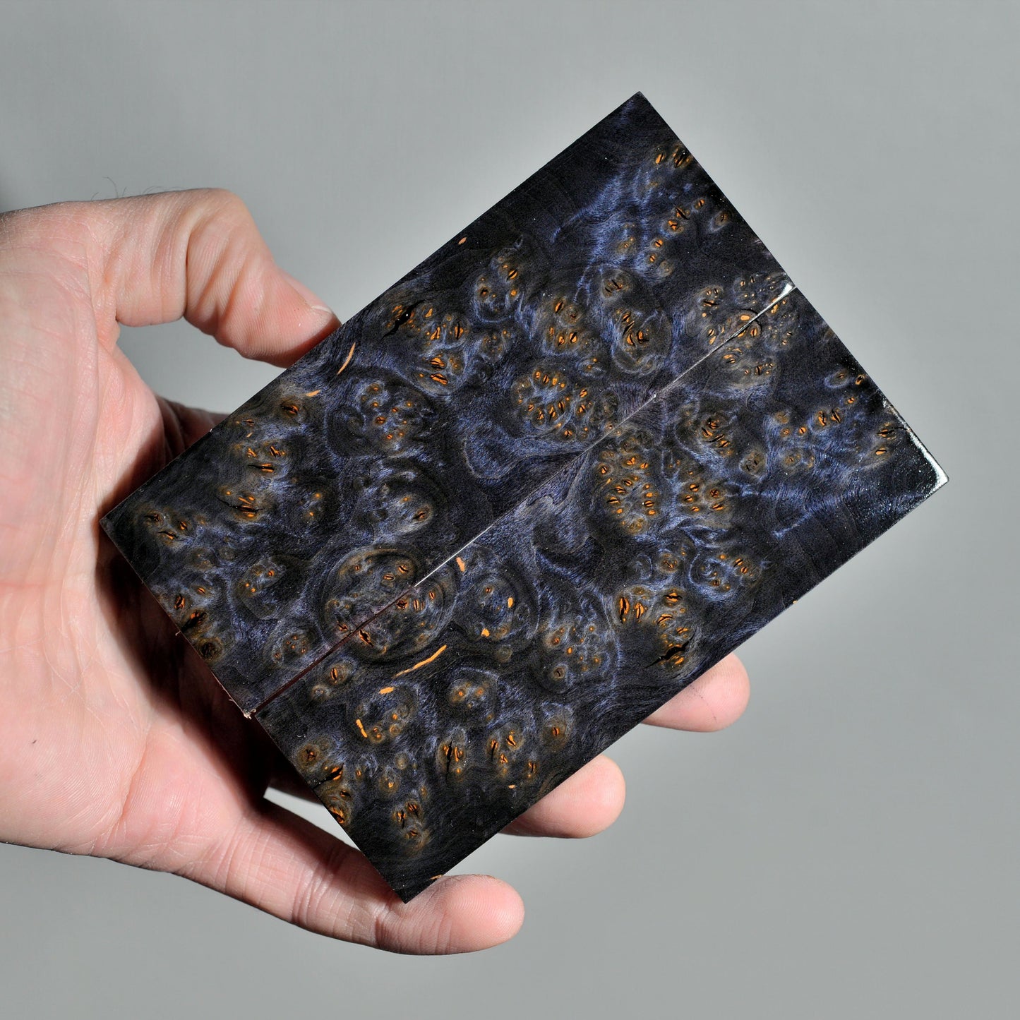 Pair of stabilized burl wood knife handle scales with dark figured grain and natural burl pattern