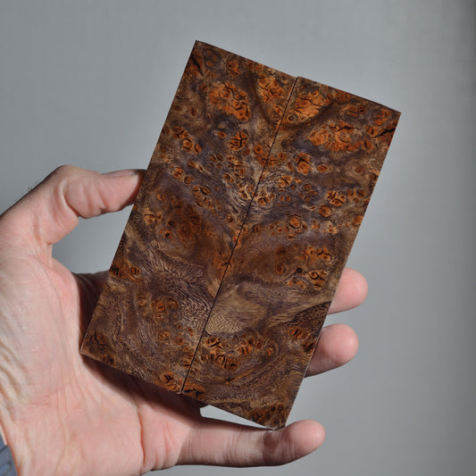 Premium stabilized wood knife scales featuring symmetrical burl pattern