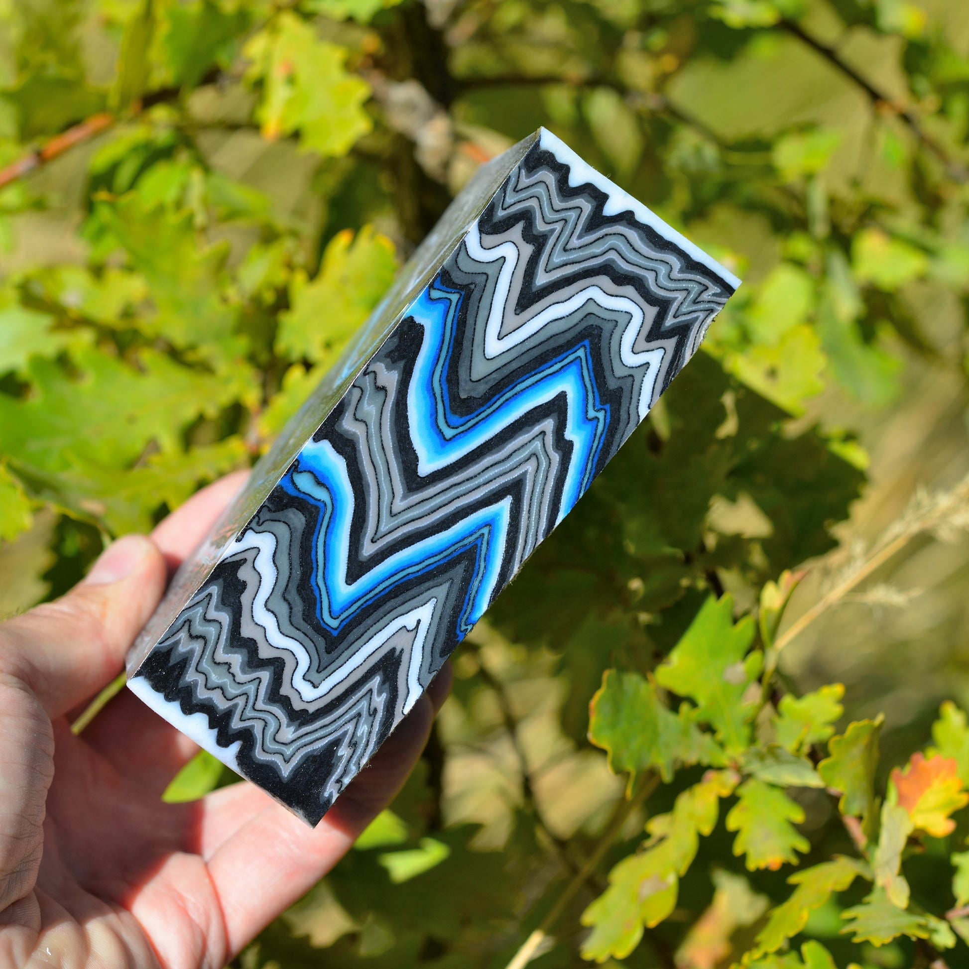 Custom micarta block featuring bright blue accents and chaotic graphite layers