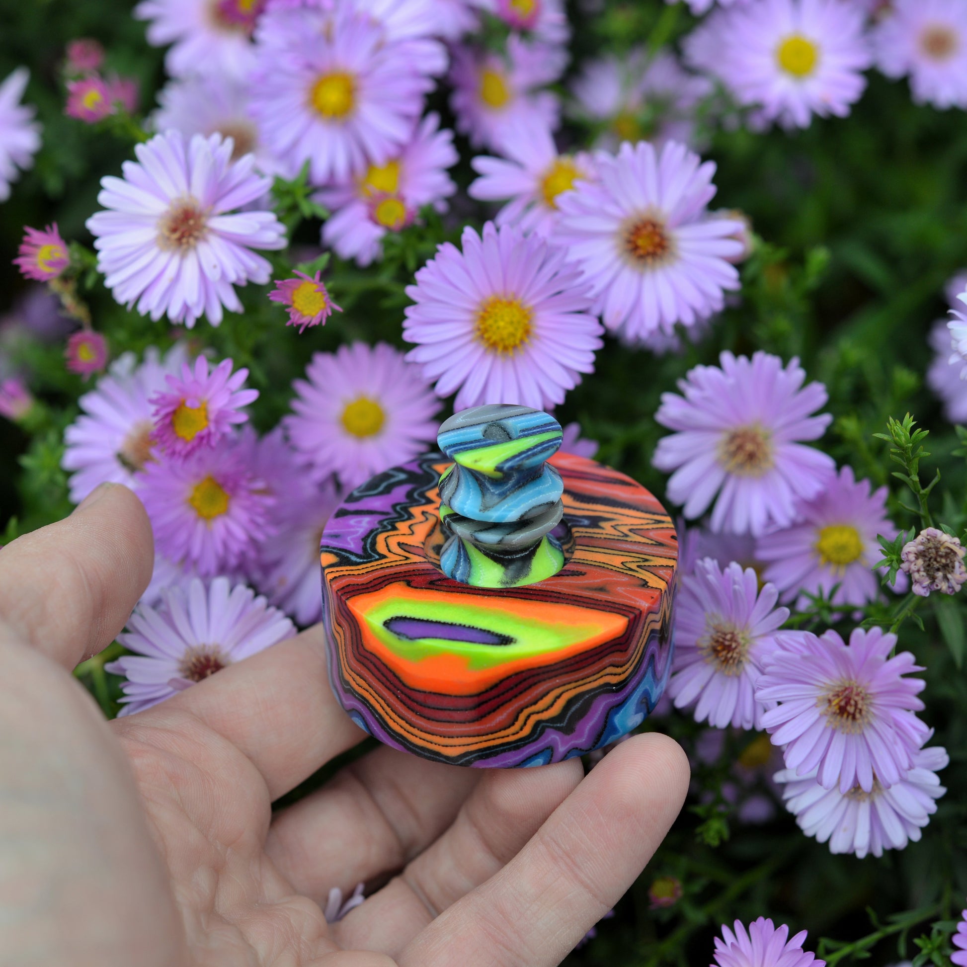 Handmade custom micarta knife bead with colorful layered pattern, designed for knife lanyard