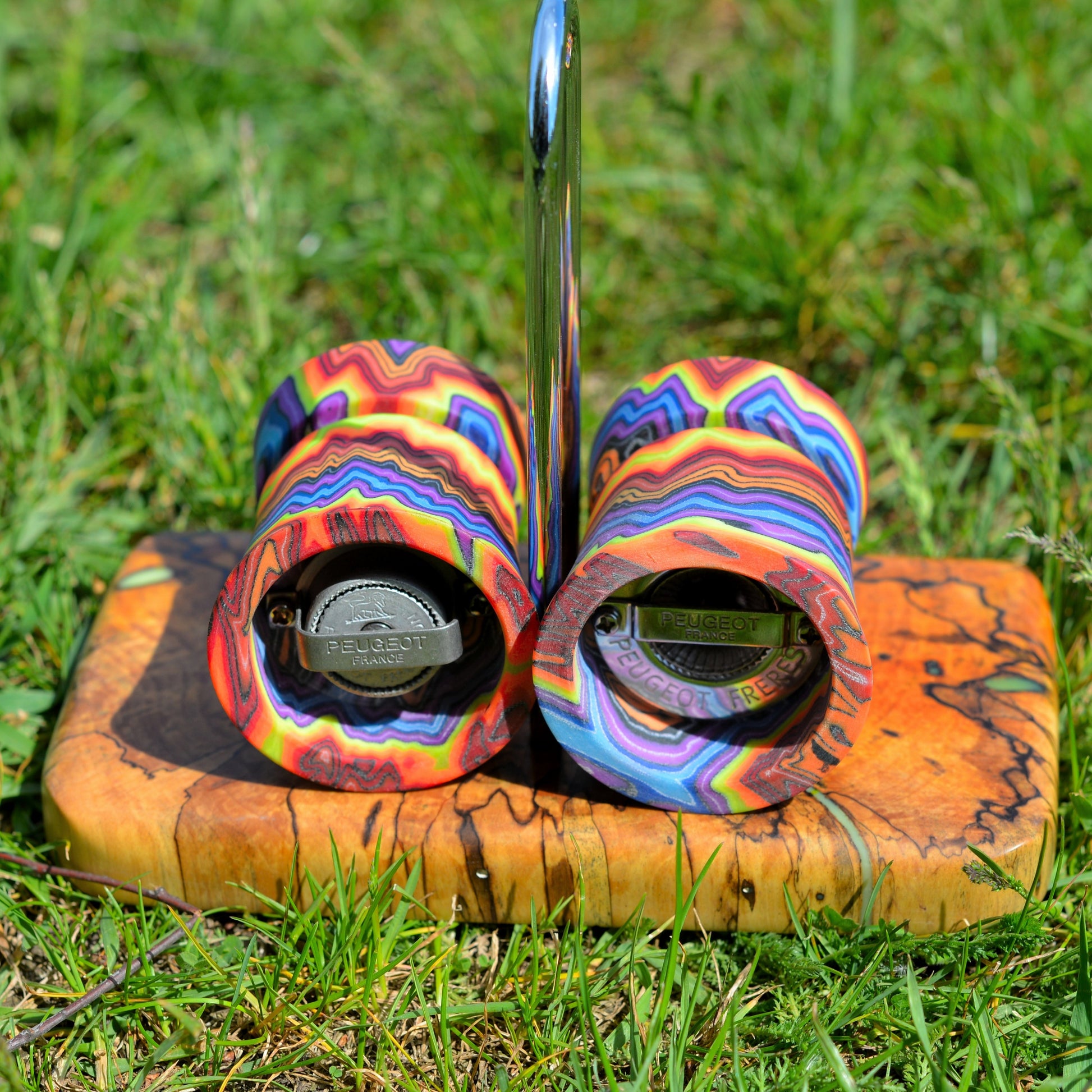 Handmade Peugeot salt and pepper grinders featuring micarta composite bodies and stabilized wood base, custom artisan kitchen set