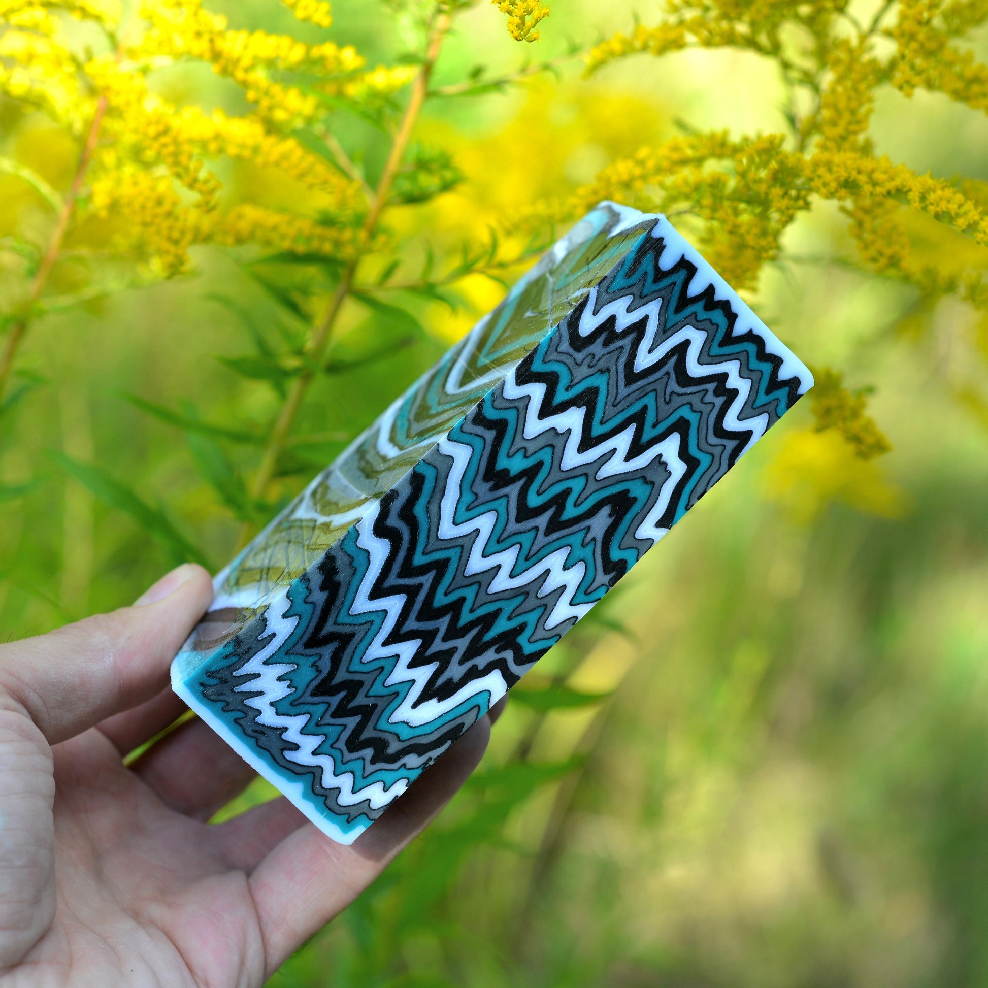 Handmade micarta block with turquoise, black, and white zigzag layered pattern