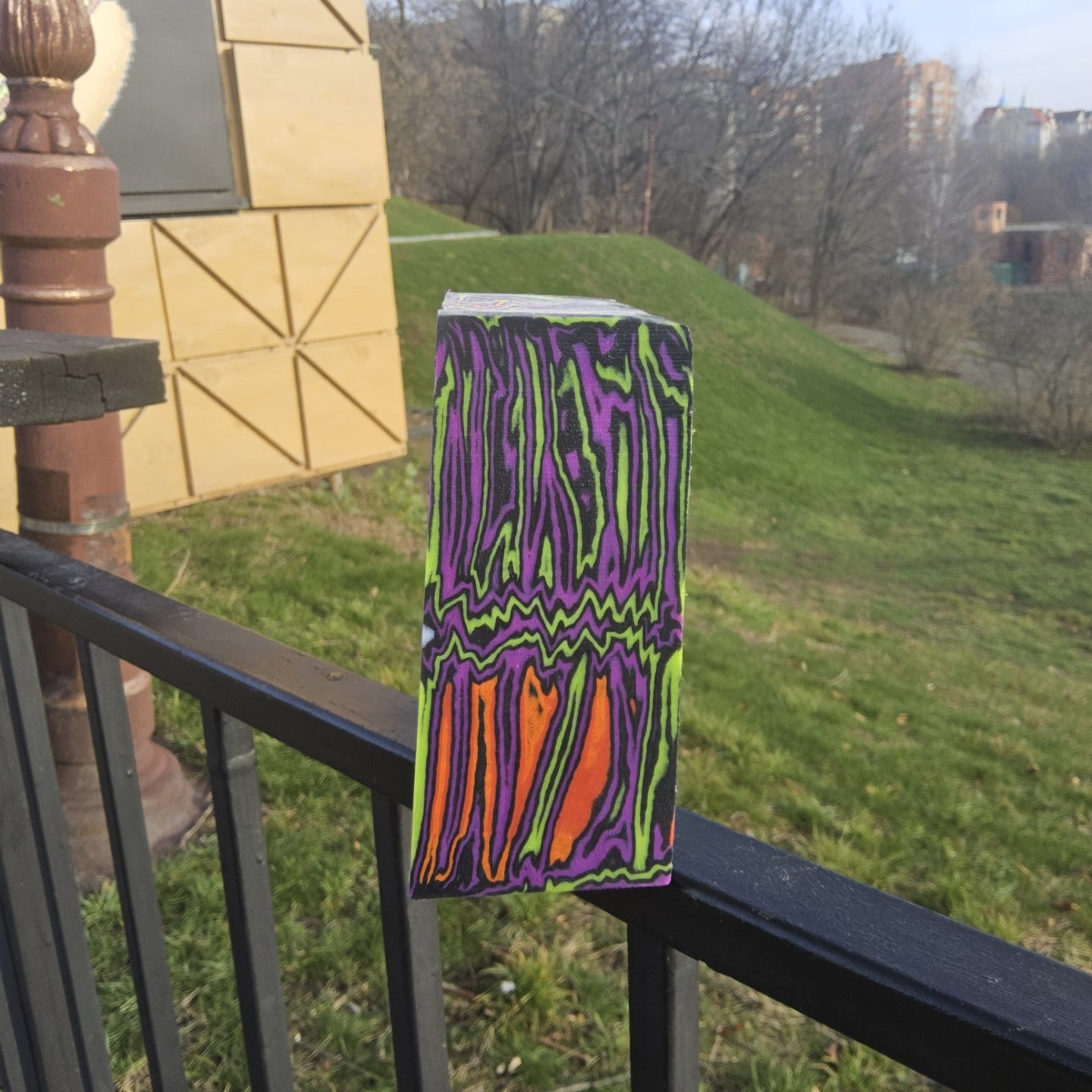 Pair of handmade micarta knife scales with neon green, purple and orange zigzag pattern.