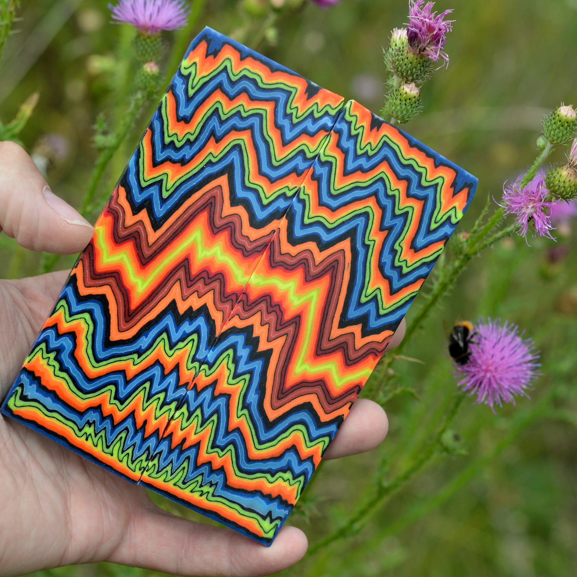 Neon multicolor zigzag micarta composite block with layered high-contrast pattern
