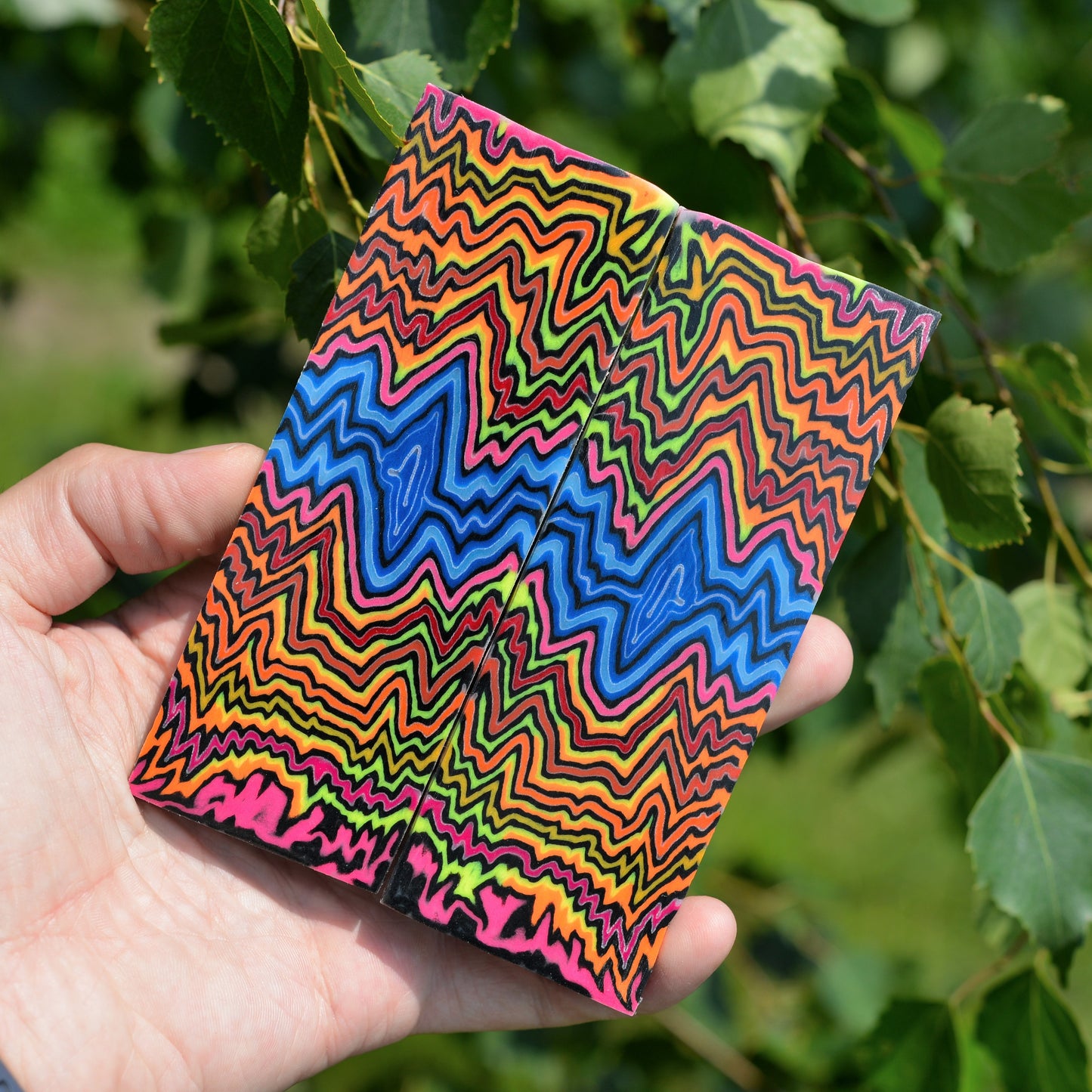 Handmade multicolor micarta handle material with vibrant trippy wave patterns for professional knife making and custom handles.