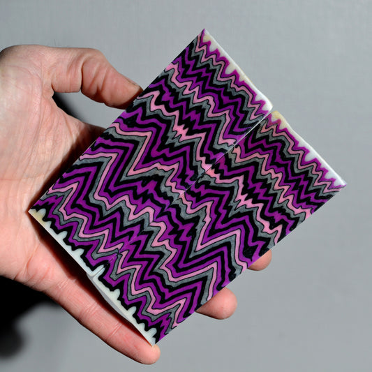 Handmade knife handle scales made from purple black and gray layered micarta with zigzag pattern