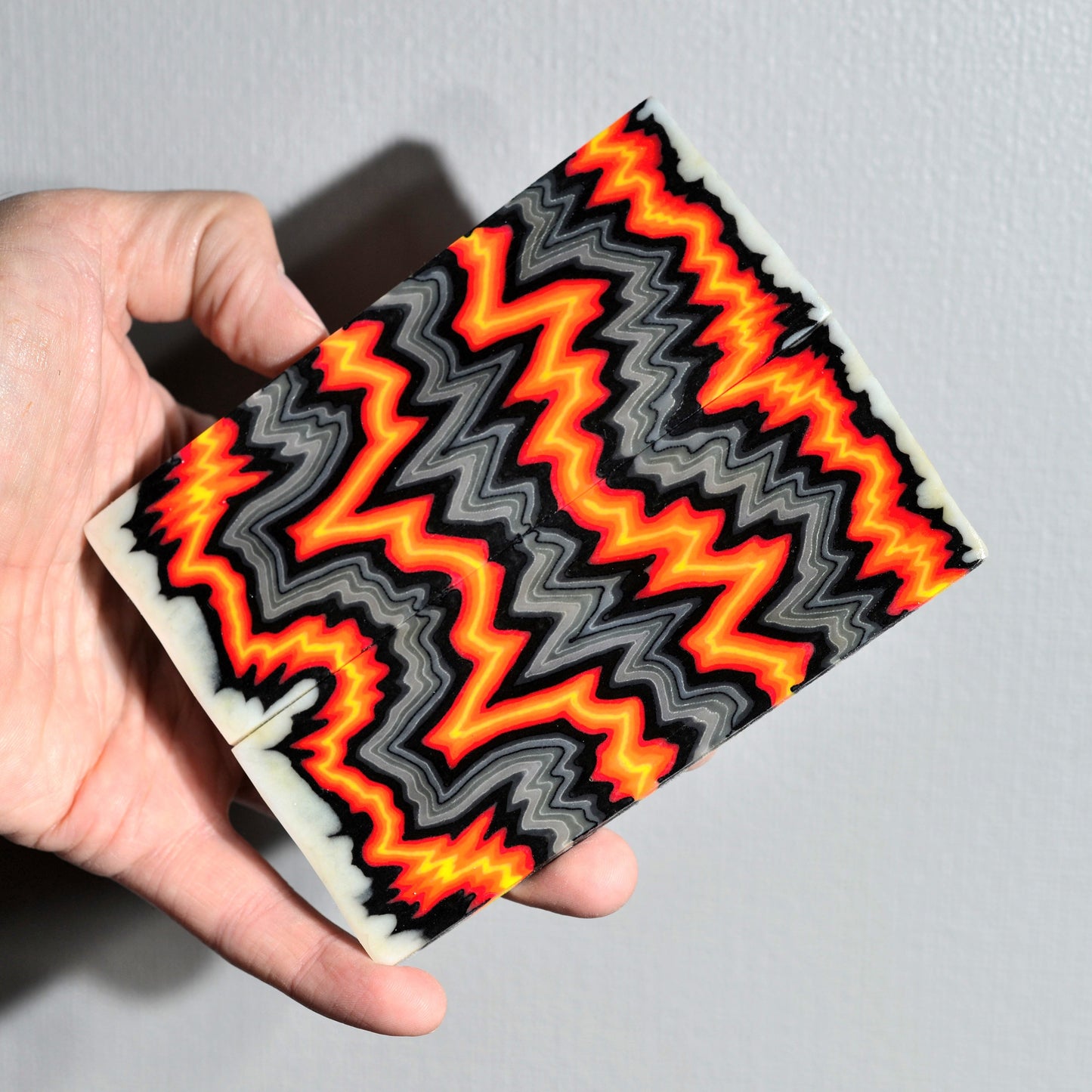 Handmade micarta-style composite handle scales in red, orange and gray colors for custom knife making #08