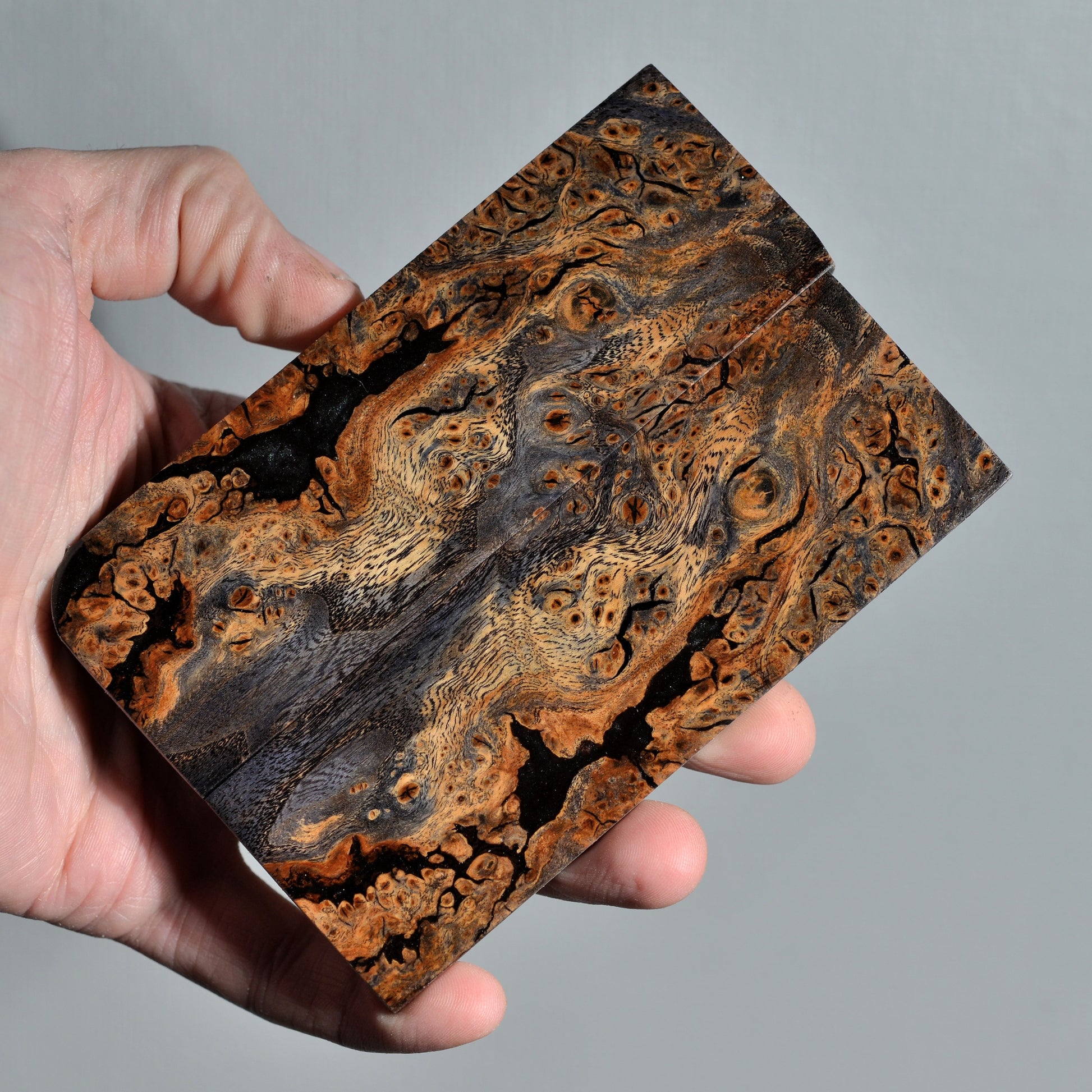 Stabilized elm burl knife handle scales with natural brown and black grain, handmade wood material
